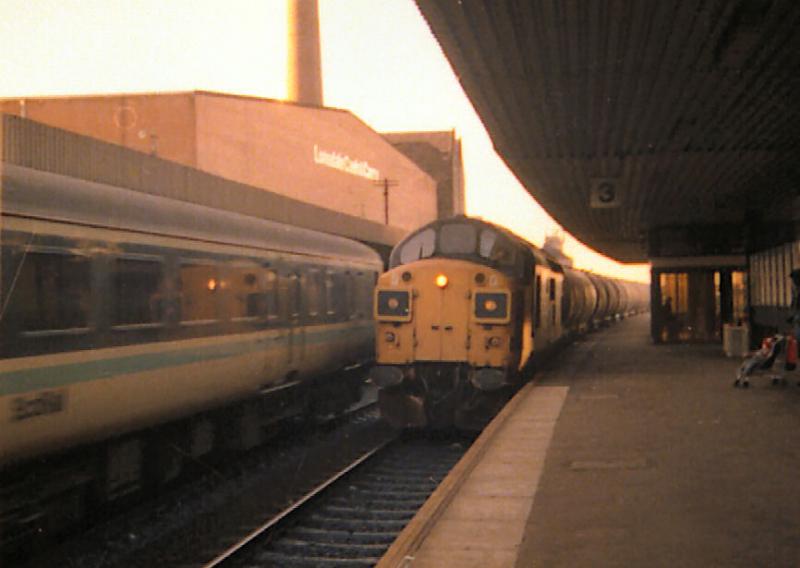 Photo of 37011 with the Grangemouth - Jarrow tanks at Haymarket.