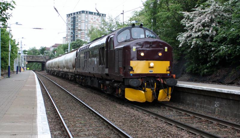 Photo of 37676 + 6 alcan tanks going for repair.