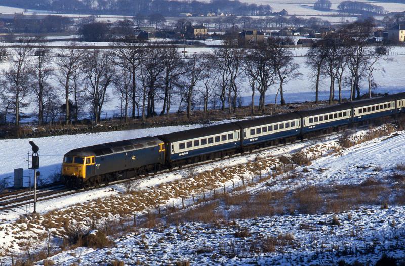 Photo of Class 47 heads through the snow to Midcalder Junction